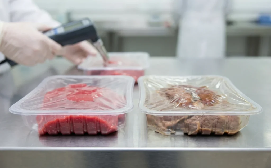 Quality control check on meat trays to solve discolored product issues from a map packaging machine.